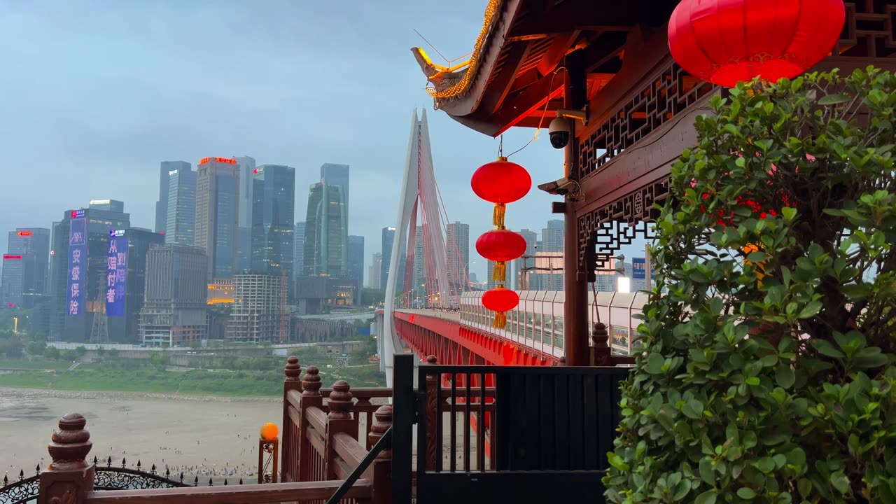 Chongqing skyline and bridge seen from a traditional riverside viewpoint.